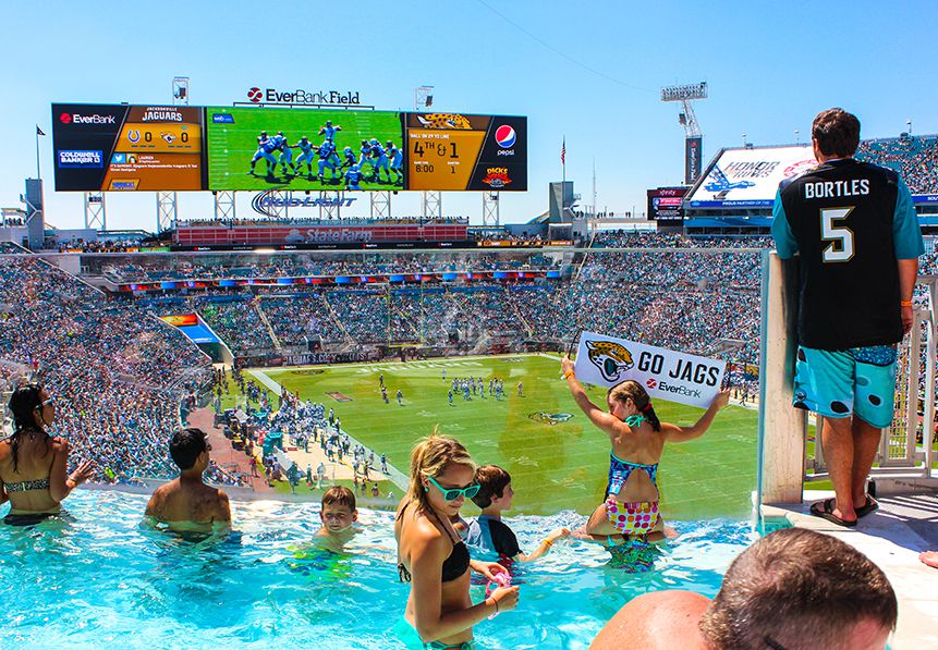fans watching the game from a swimming pool in a private cabana at Jacksonville Jaguars stadium